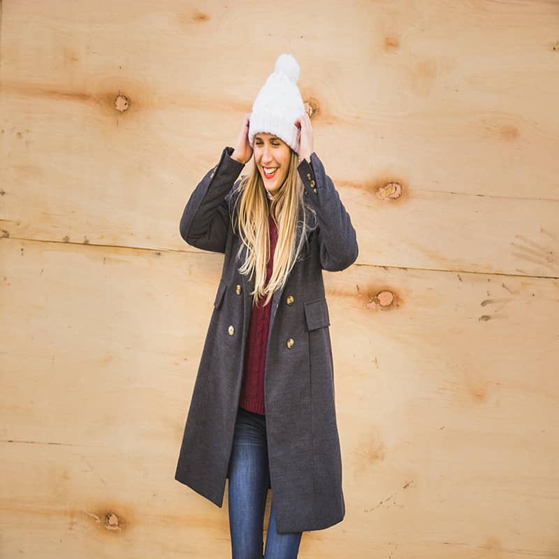 beautiful-model-adjusting-hat-smiling
